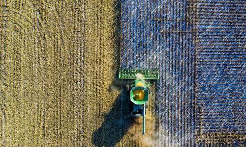 A birds eye view of a tractor on a field.